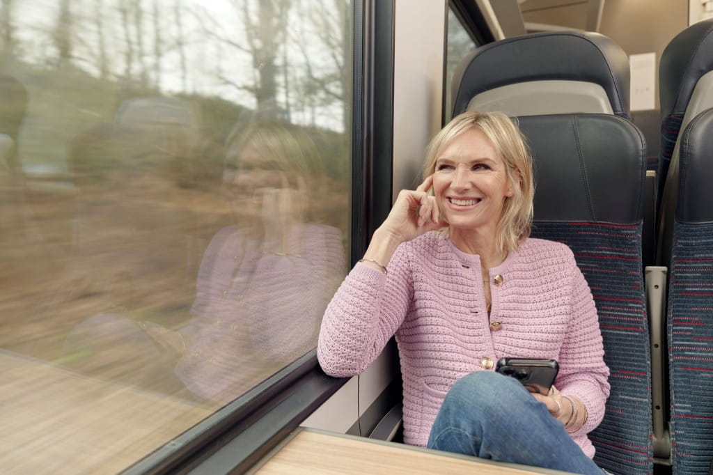Radio presenter Jo Whiley looking out of the window of  a train