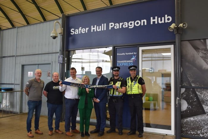 Seven people stood in front of the Safer Hull Paragon Hub at the grand opening