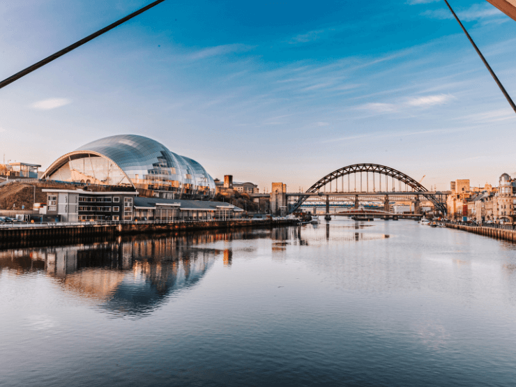 A city landscape of Newcastle with a curved bridge visible