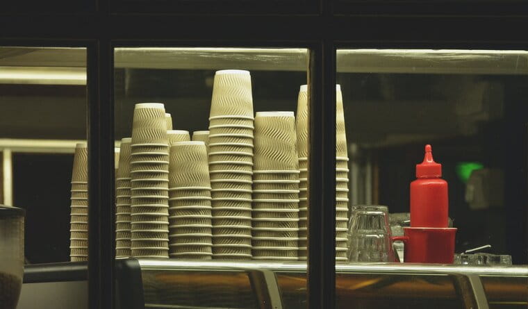 Disposable cups and ketchup bottle in a takeaway