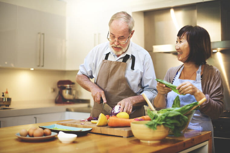 Older man and woman cooking a meal