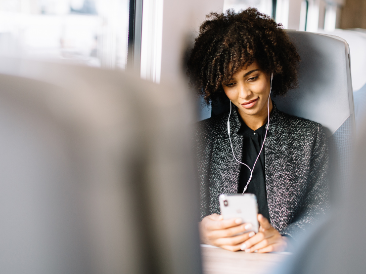 A woman commuting on the train using her phone